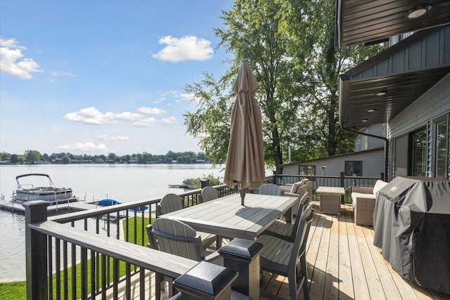 wooden deck with a water view and area for grilling