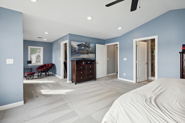 bedroom with lofted ceiling, a walk in closet, light colored carpet, and ceiling fan