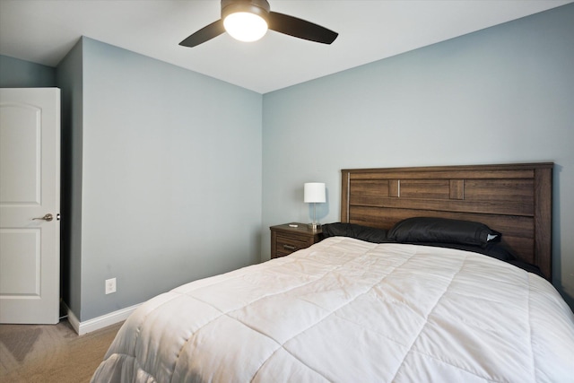 bedroom featuring light carpet and ceiling fan