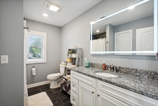 bathroom featuring vanity and toilet