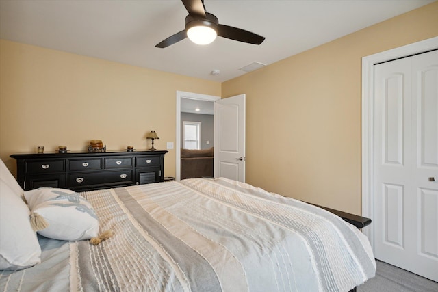 carpeted bedroom with a closet and ceiling fan