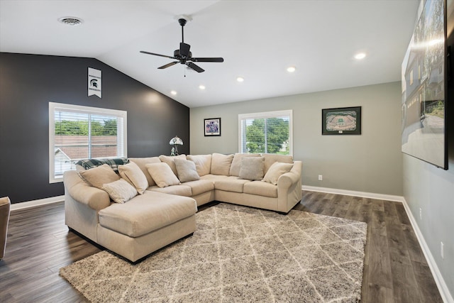 living room featuring dark hardwood / wood-style flooring, vaulted ceiling, and ceiling fan