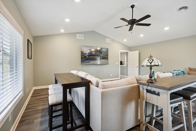 living room with ceiling fan, lofted ceiling, and dark hardwood / wood-style flooring