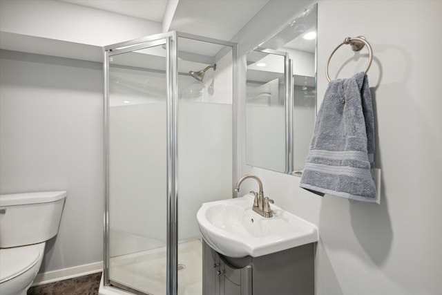 bathroom featuring vanity, toilet, and an enclosed shower