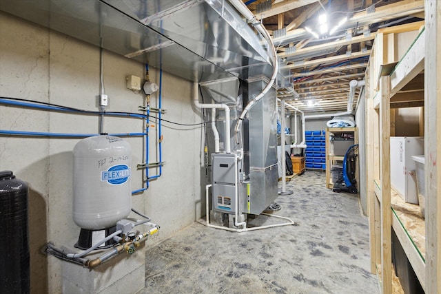 utility room featuring heating unit