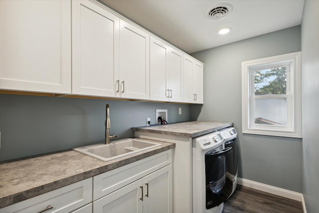 laundry area featuring dark wood-type flooring, cabinets, hookup for a washing machine, and sink