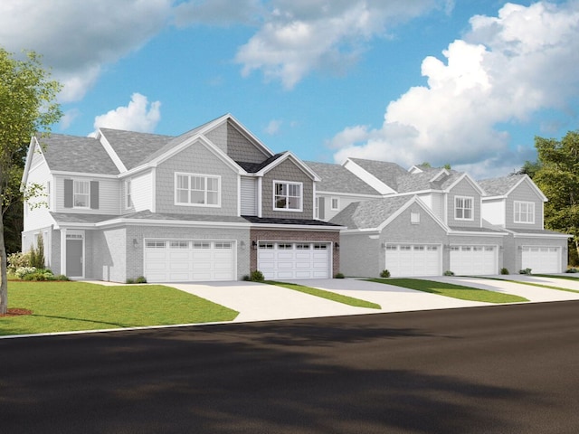 view of front of home with a front lawn, roof with shingles, concrete driveway, and an attached garage