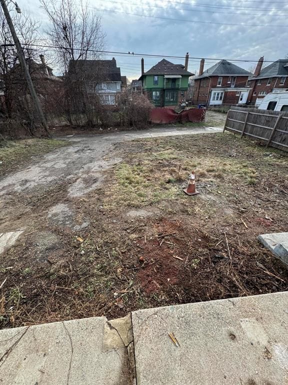 view of yard featuring a residential view and fence