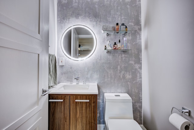 bathroom featuring ceiling fan, vanity, and toilet