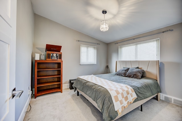 bedroom with carpet floors, lofted ceiling, visible vents, and baseboards