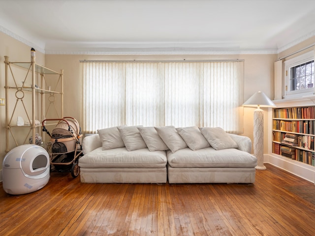 living room featuring crown molding and hardwood / wood-style flooring