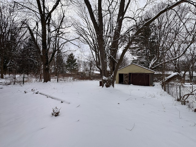 yard covered in snow with a garage