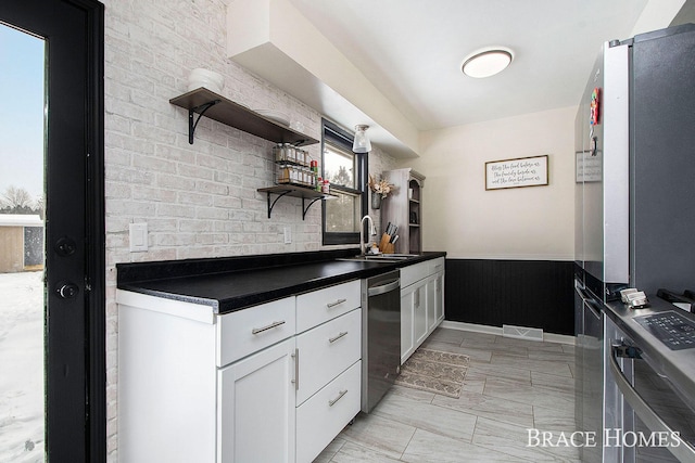 kitchen featuring sink, stainless steel appliances, and white cabinets