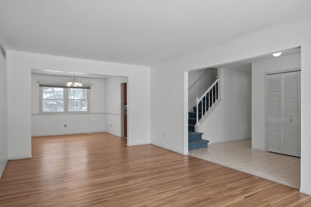 interior space featuring light wood-type flooring and a notable chandelier