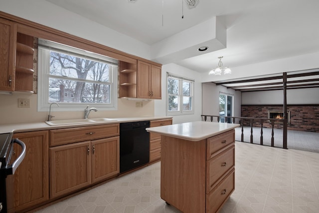 kitchen with decorative light fixtures, a kitchen island, black dishwasher, plenty of natural light, and sink