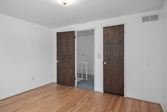 unfurnished bedroom with light wood-type flooring