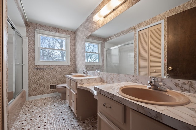 full bathroom featuring tile patterned floors, vanity, shower / bath combination with glass door, and toilet