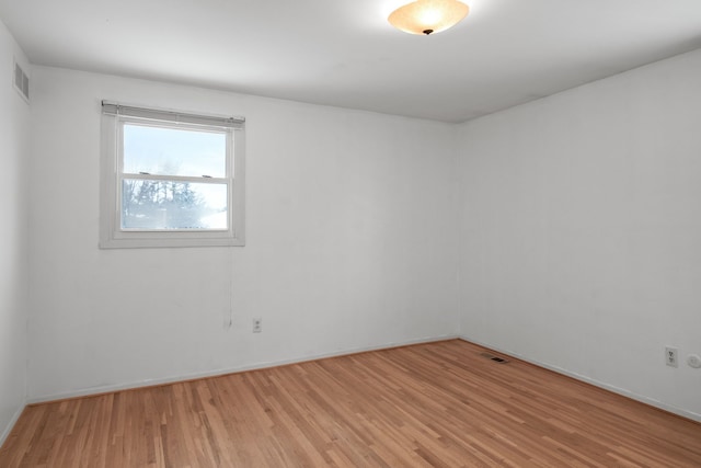 spare room with light hardwood / wood-style flooring