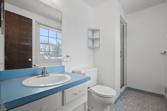 bathroom featuring vanity, tile patterned flooring, an enclosed shower, and toilet