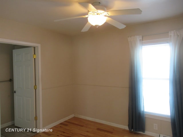 unfurnished room featuring ceiling fan and wood-type flooring