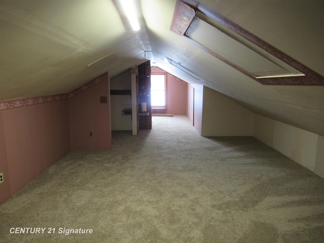 bonus room featuring lofted ceiling and light carpet