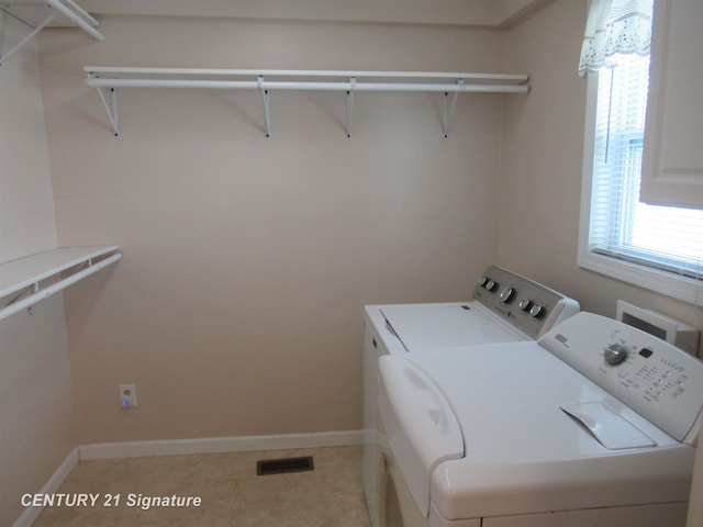 clothes washing area with separate washer and dryer