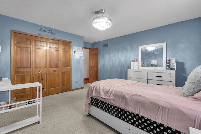 bedroom with a textured ceiling and carpet flooring