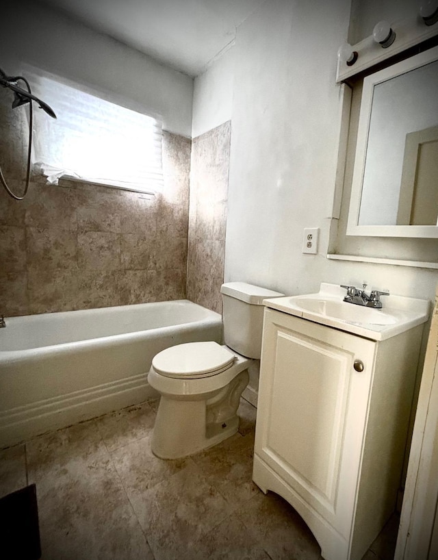 full bathroom featuring vanity, tiled shower / bath, and toilet