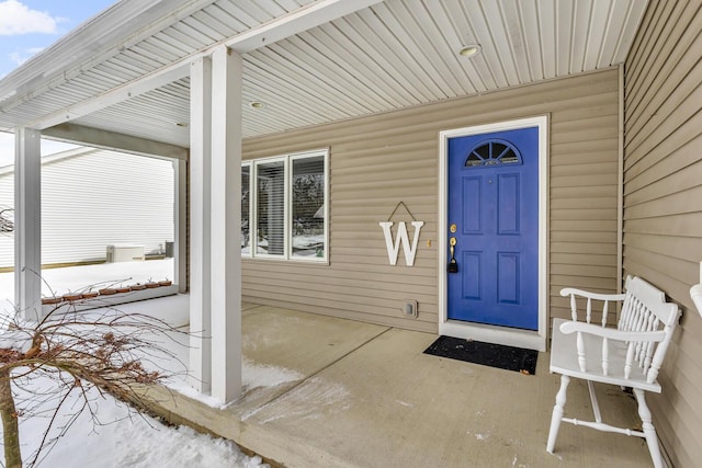 view of snow covered property entrance