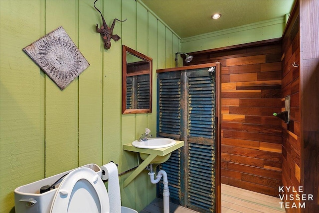 bathroom with wooden walls and toilet