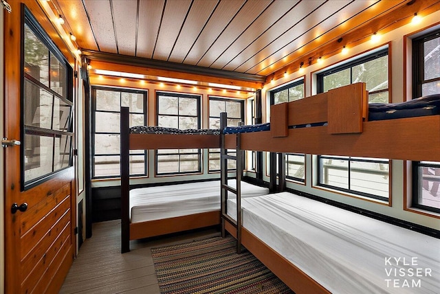 bedroom featuring hardwood / wood-style floors and wooden ceiling