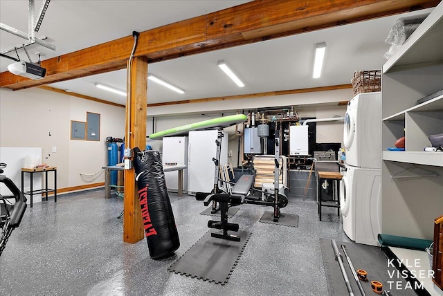 gym with stacked washer / drying machine and electric panel