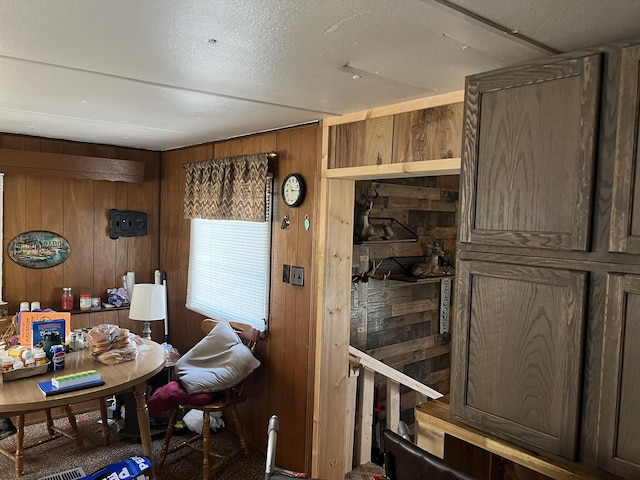 dining room with wooden walls