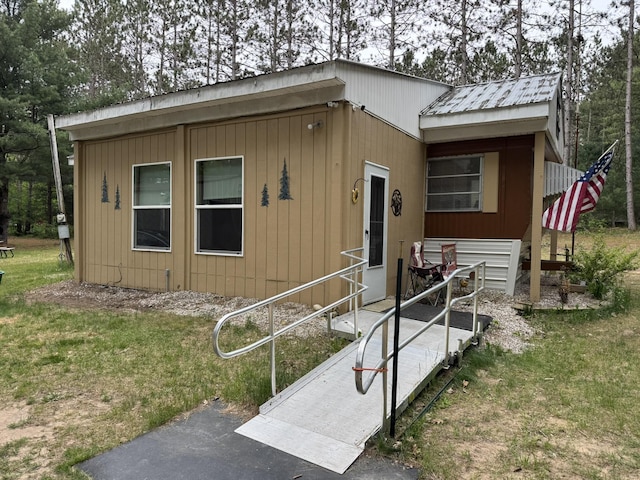 8210 N Johnson Rd, Irons, MI 49644 - view of front of house featuring a front lawn and metal roof