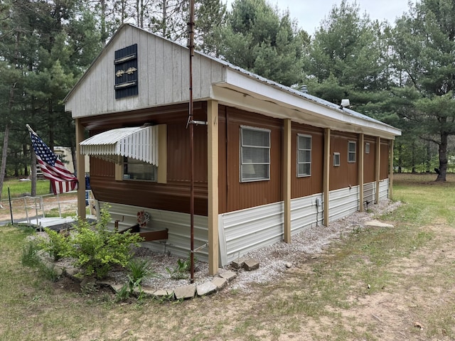 8210 N Johnson Rd, Irons, MI 49644 - view of property exterior featuring metal roof and a detached garage
