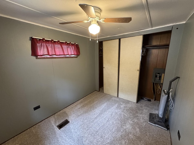 8210 N Johnson Rd, Irons, MI 49644 - unfurnished bedroom with carpet floors, a ceiling fan, and a closet