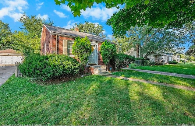 view of front of house with a garage and a front lawn