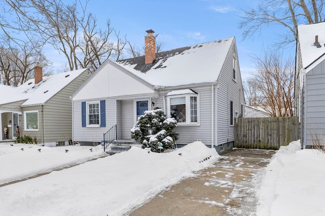 view of front of home with fence and a chimney