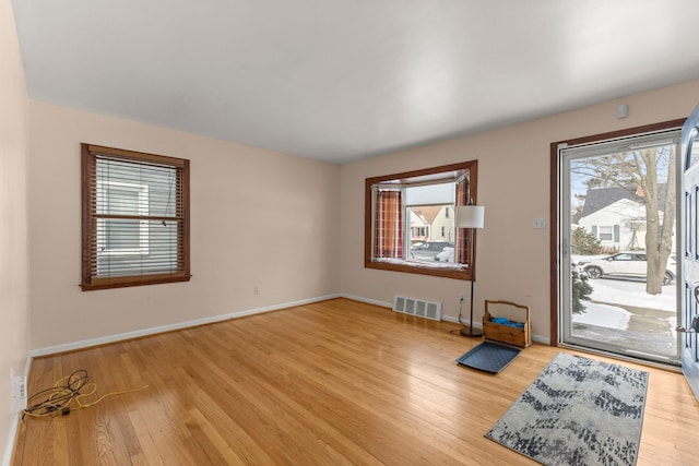 entrance foyer featuring baseboards, visible vents, and light wood-style floors