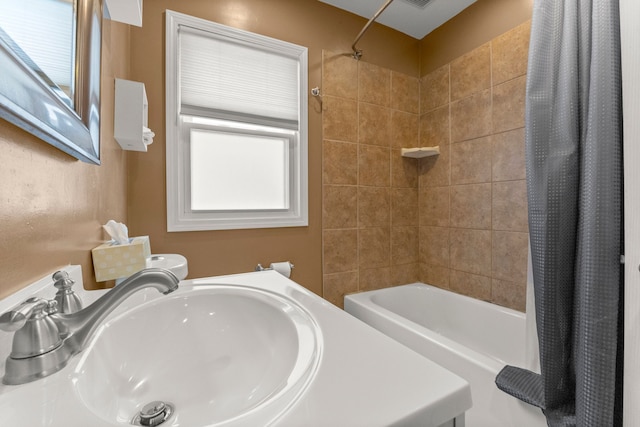 bathroom with shower / bath combo and a sink