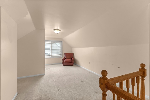 additional living space with vaulted ceiling, carpet, and baseboards