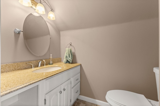 bathroom with toilet, baseboards, and vanity