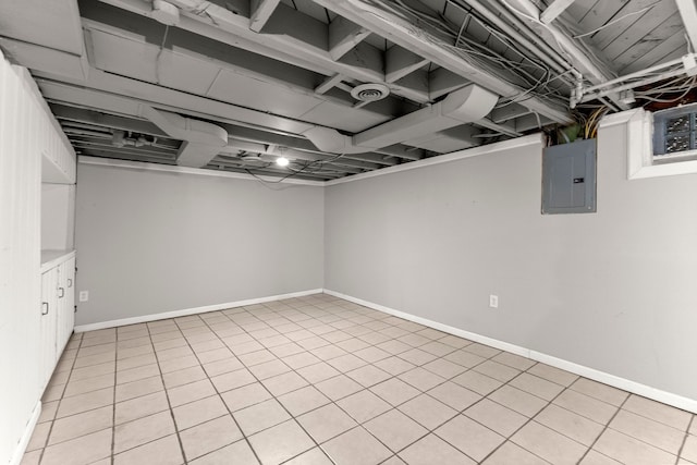 below grade area with electric panel, baseboards, and light tile patterned flooring