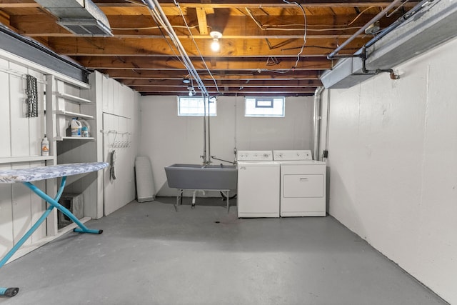 basement featuring a sink and separate washer and dryer