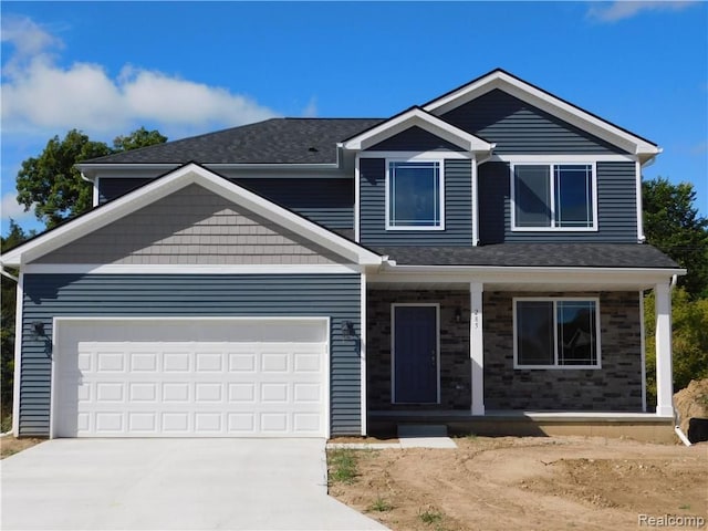 view of front of house with a garage and covered porch