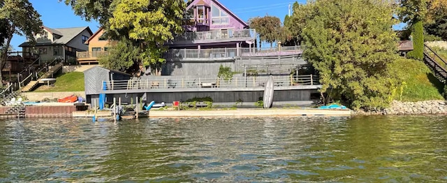 back of property featuring a water view