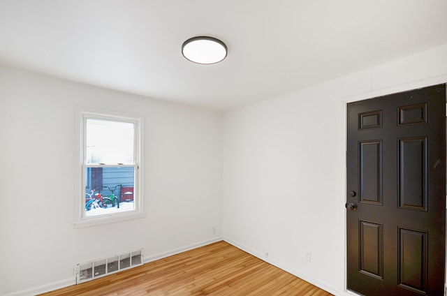 empty room with hardwood / wood-style flooring