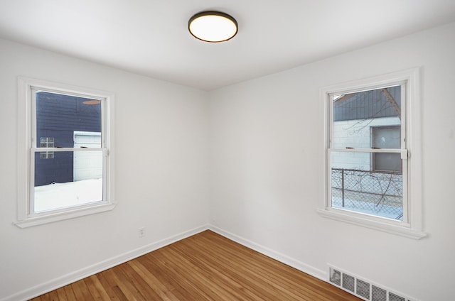 empty room with hardwood / wood-style flooring