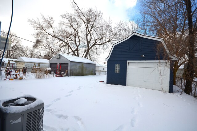 snow covered garage with central AC