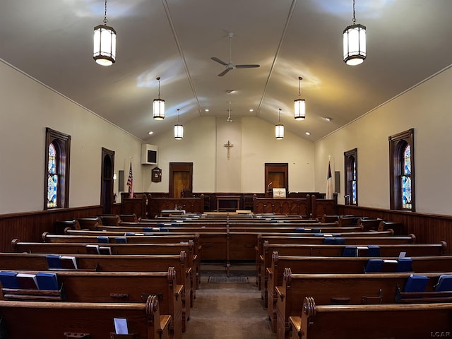 miscellaneous room with vaulted ceiling, ceiling fan, and wood walls